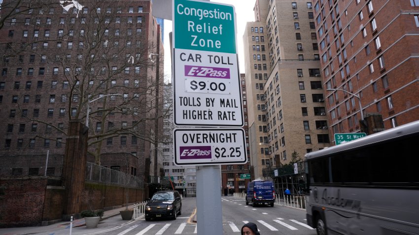 FILE – Signs advising drivers of congestion pricing tolls are displayed near the exit of the Lincoln Tunnel in New York, Wednesday, Feb. 19, 2025.